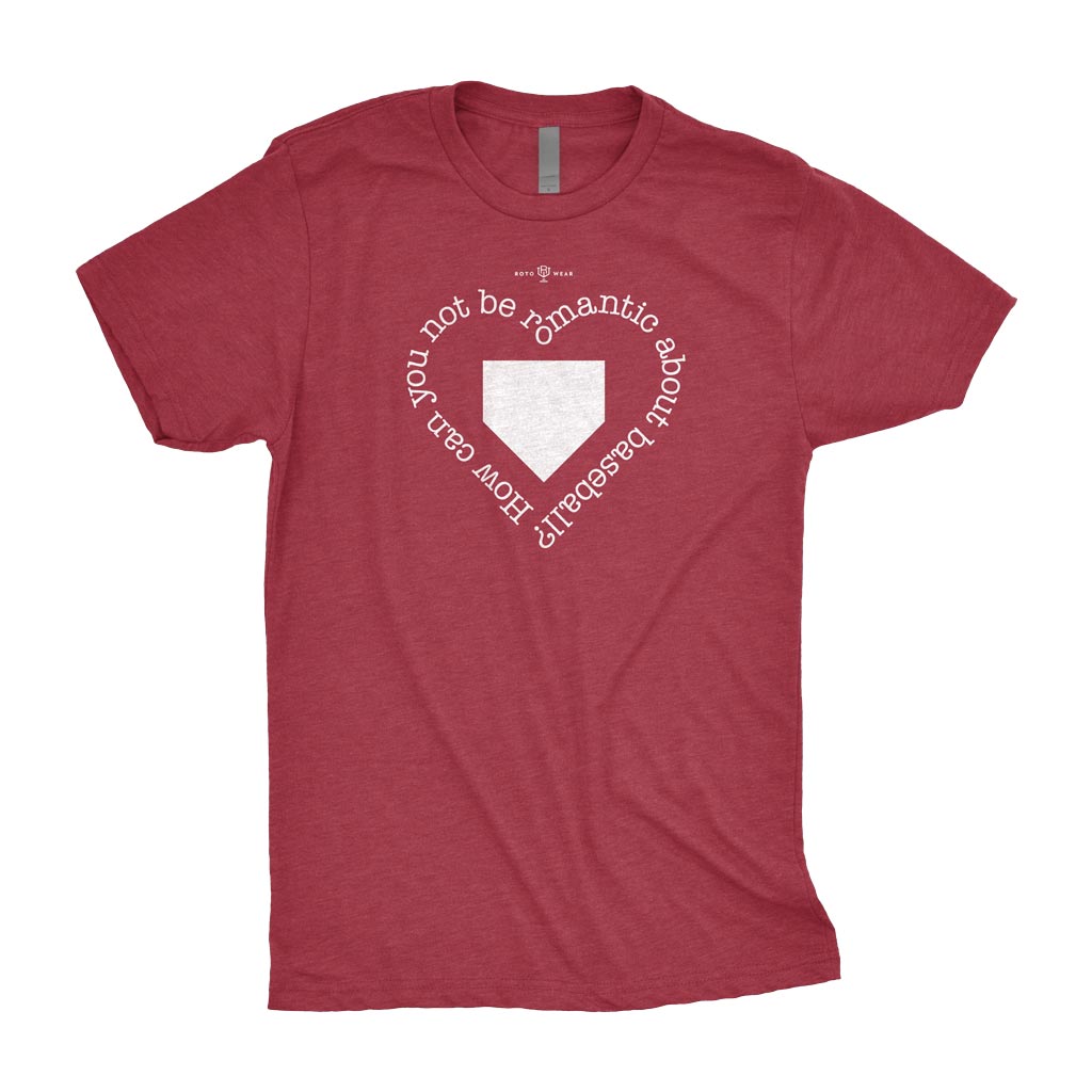 A heathered cardinal red short-sleeve t-shirt with a white graphic on the chest. The graphic features a baseball home plate shape in the center, surrounded by the text 'How can you not be romantic for your baseball' in a heart arrangement.